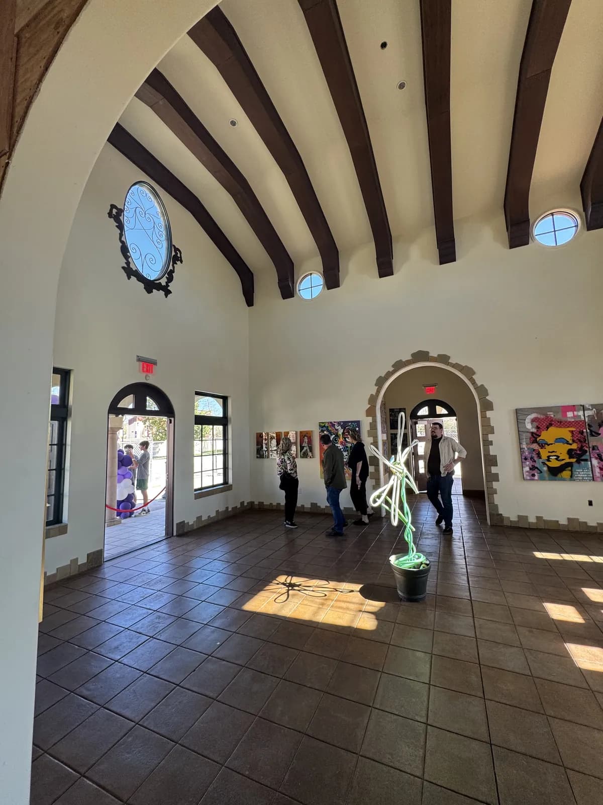 The arched hall with original work on the walls
