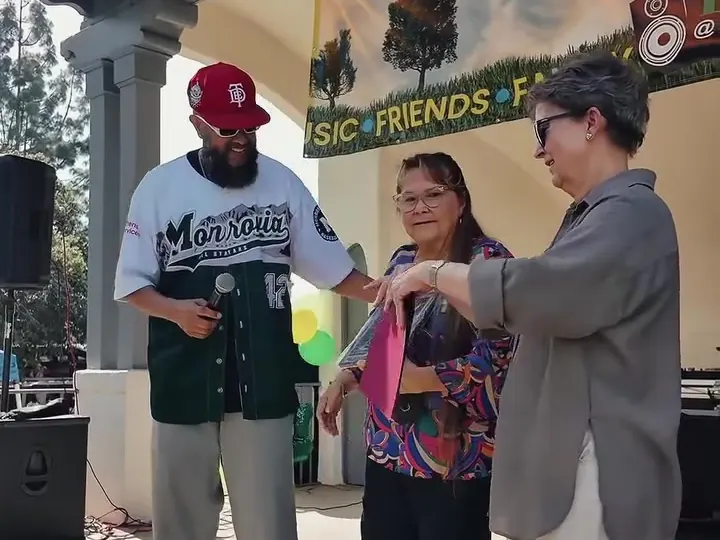 Chris Loos presenting a certificate at the bandshell