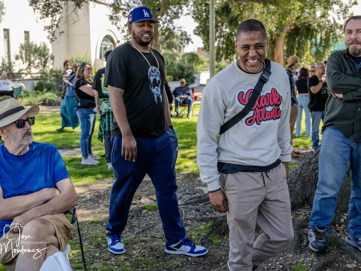 Old friends laughing together under the trees